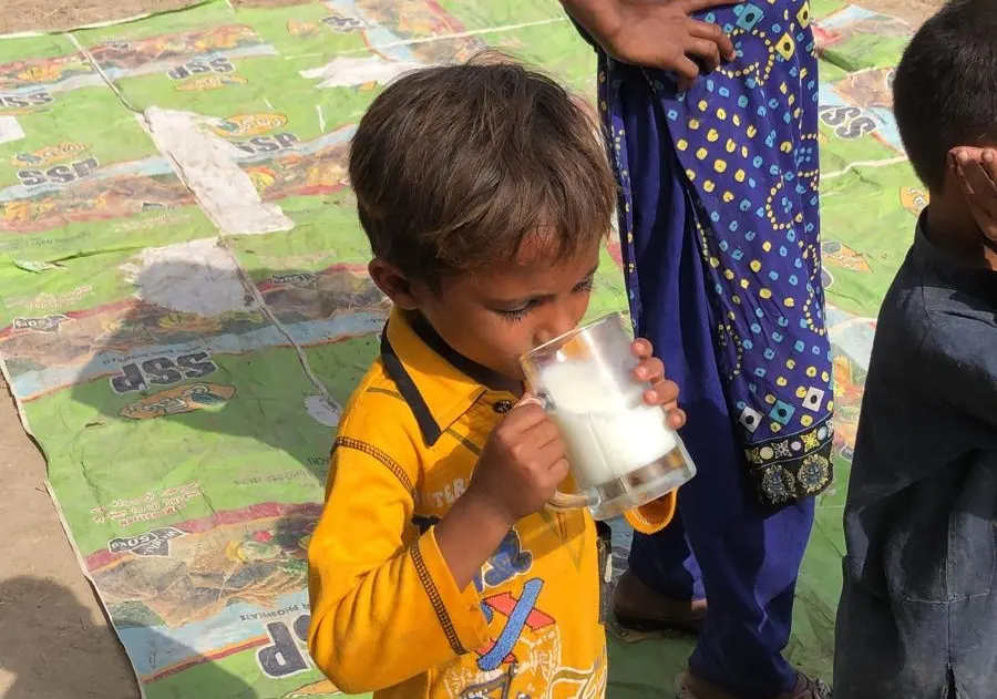 A child drinking a glass of milk